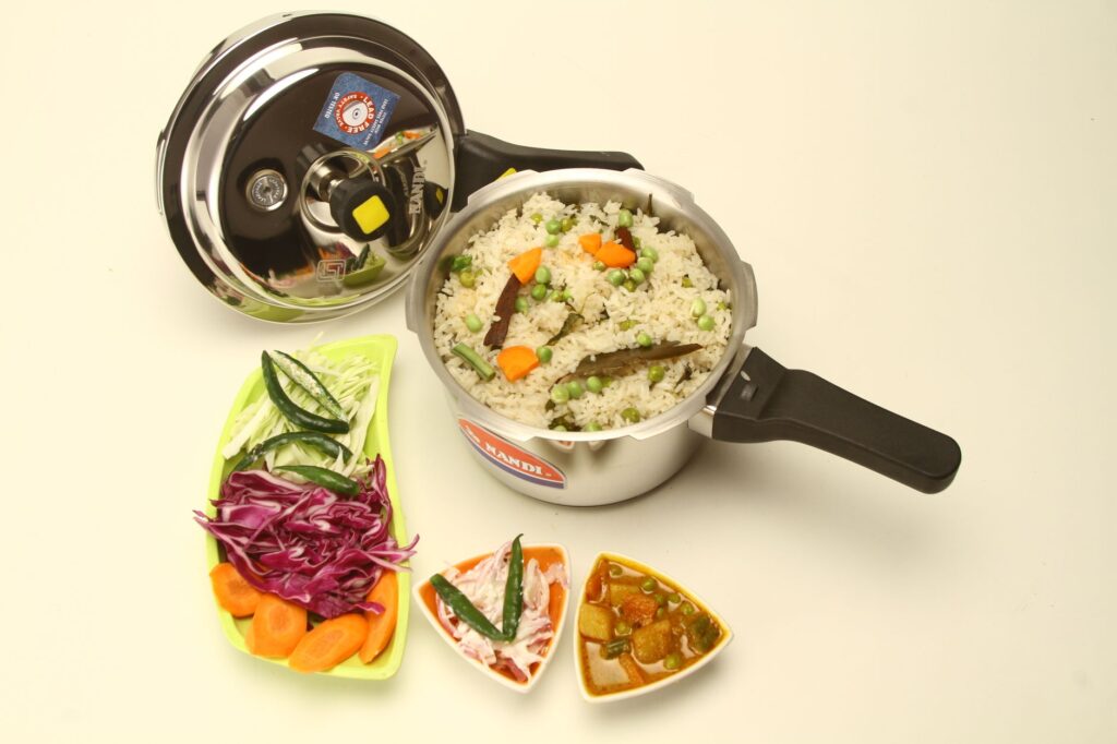 Delicious Indian vegetable pulao cooked in a pressure cooker with fresh side dishes.