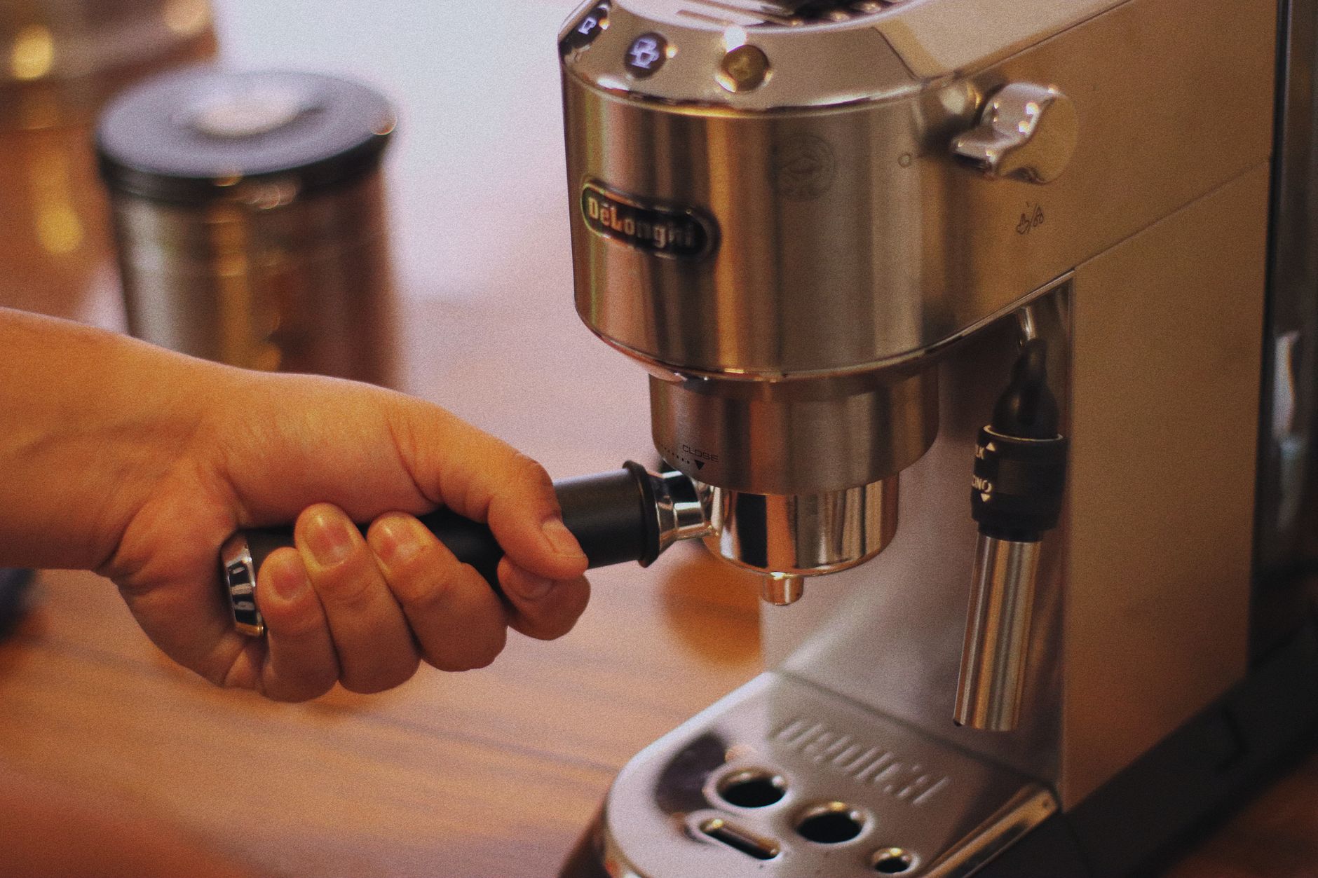 Home barista using espresso machine to make coffee