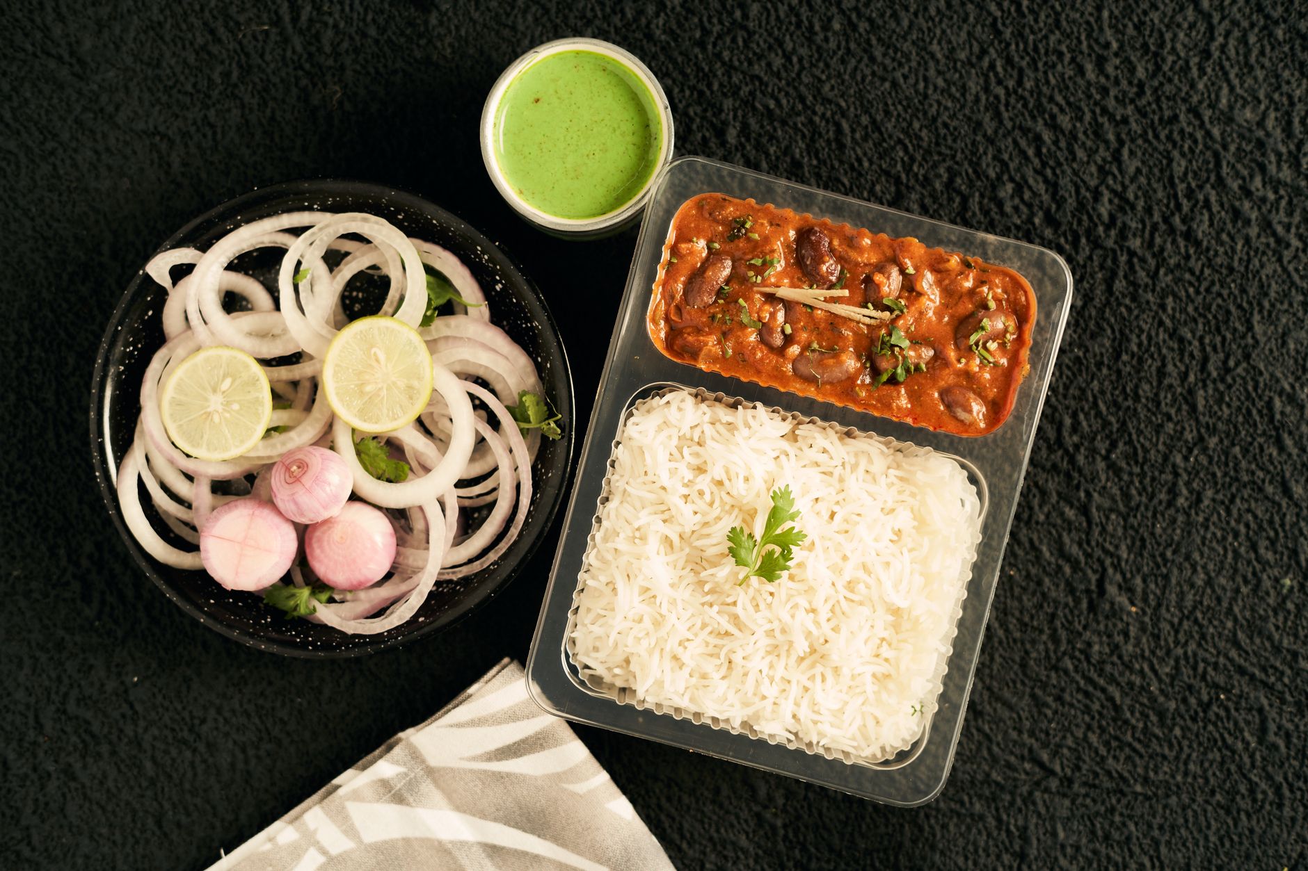 Traditional Indian meal packed in tiffin — rajma curry and rice for office lunch box