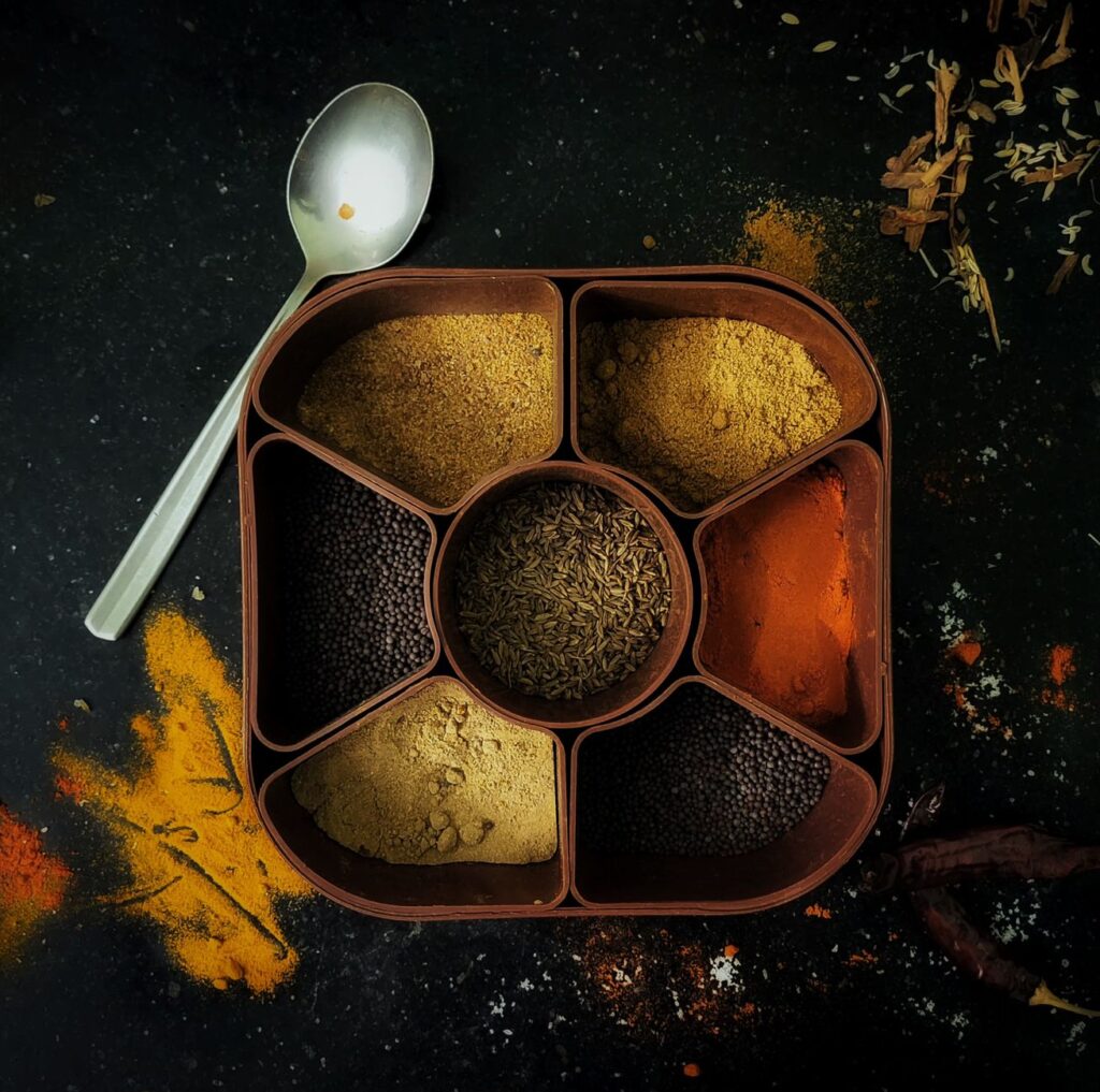 Indian masala dabba spice box with colorful spice powders for Indian kitchen