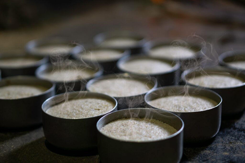 Steaming hot idlis in traditional steel molds - best idli pots in India 2026