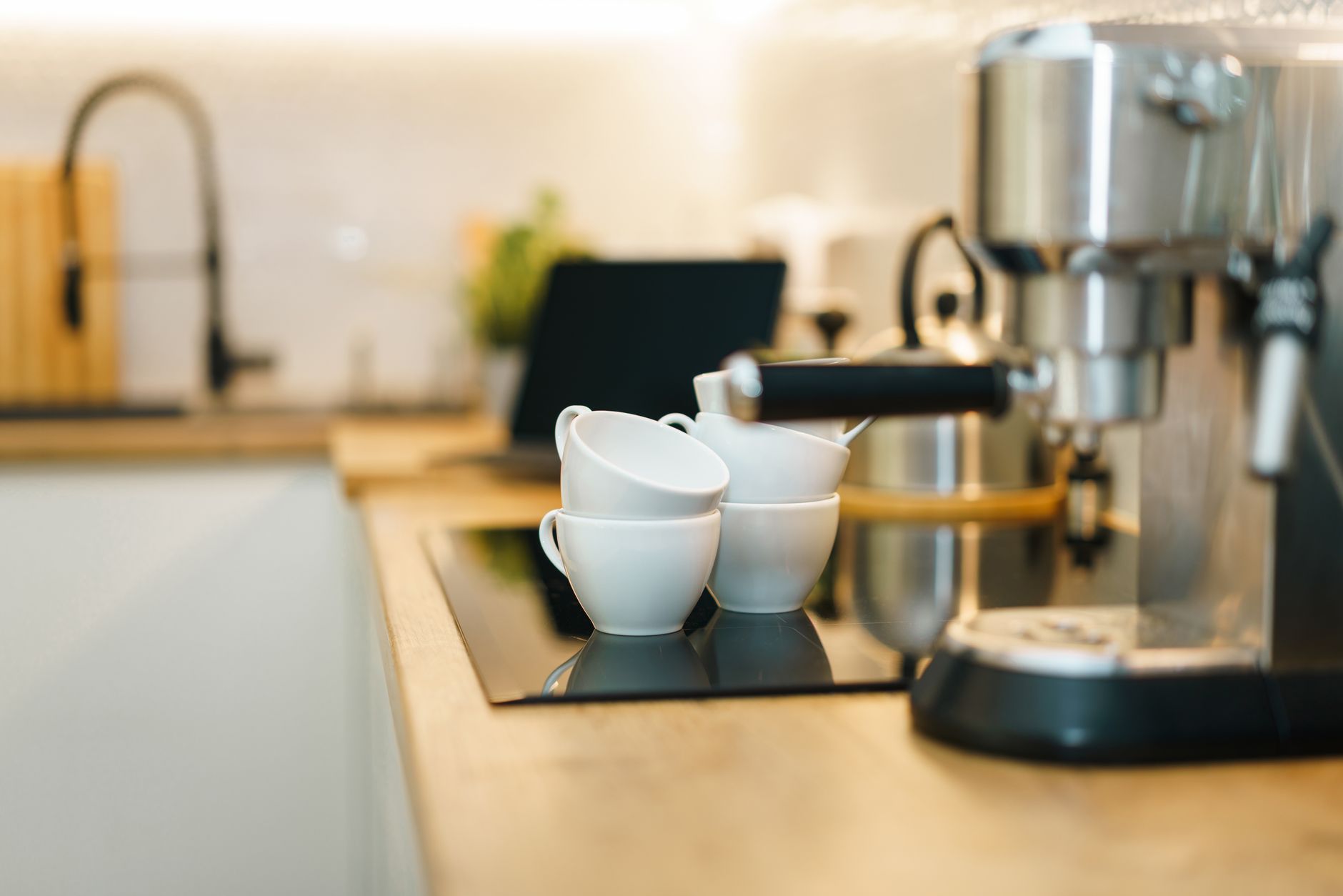 Modern espresso machine with coffee cups on kitchen counter - best coffee makers in India 2026