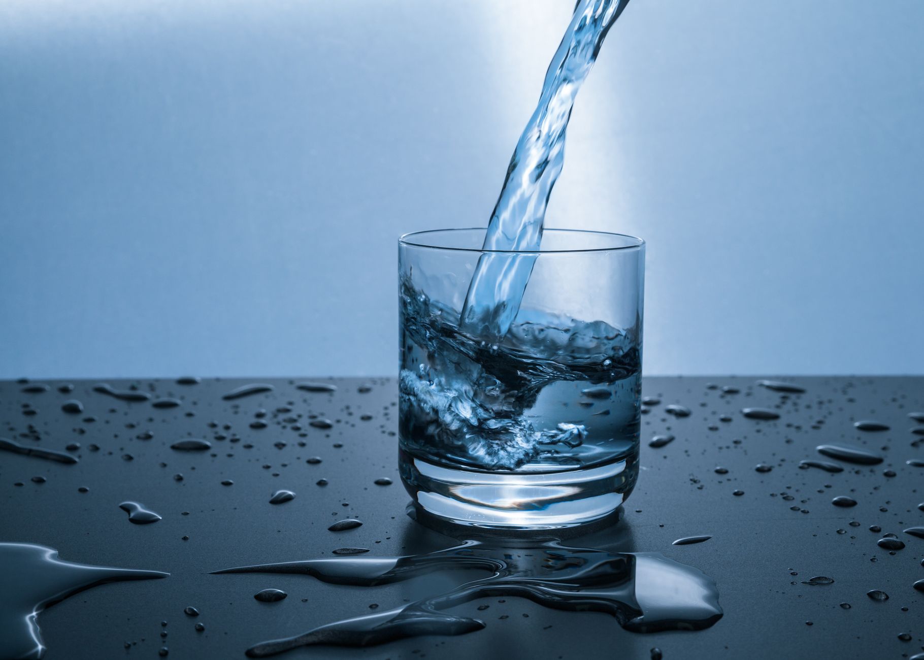 Clean purified drinking water poured in glass — water purifier buying guide India 2026
