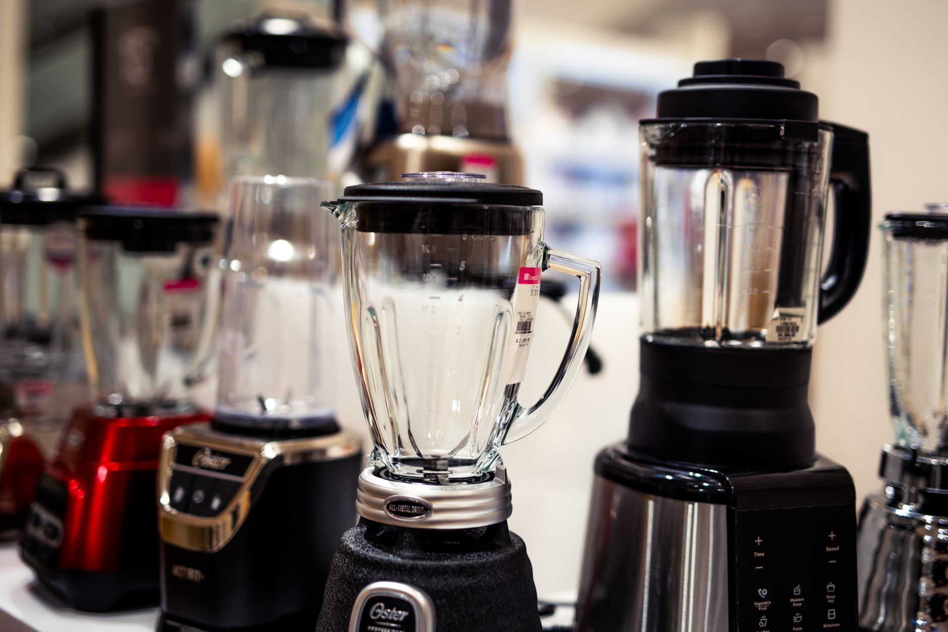 Variety of kitchen blenders and hand blenders on display countertop