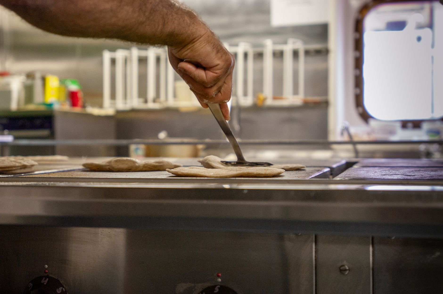 Flatbread being prepared on electric cooking surface - results from a quality roti maker in Indian kitchen