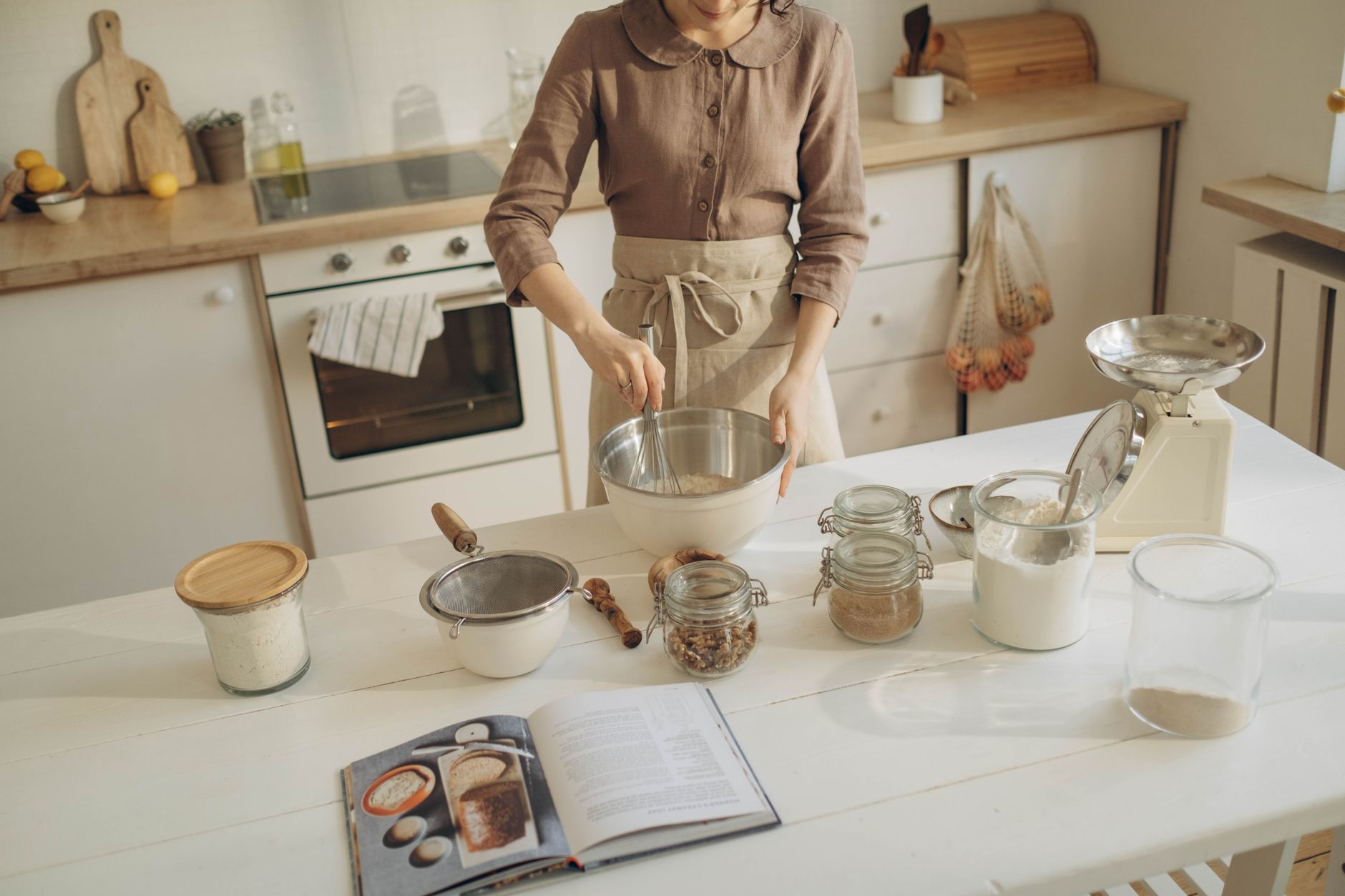Person preparing baking ingredients by weight in kitchen