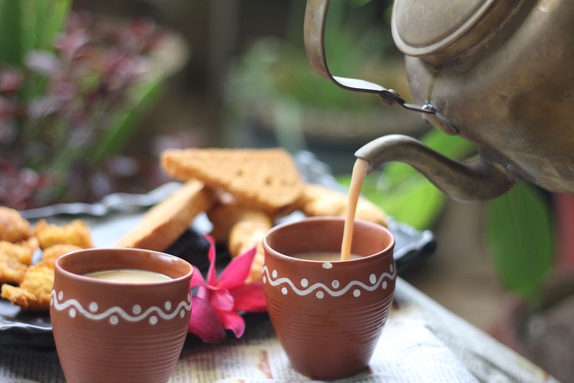 Pouring hot tea from electric kettle at home India