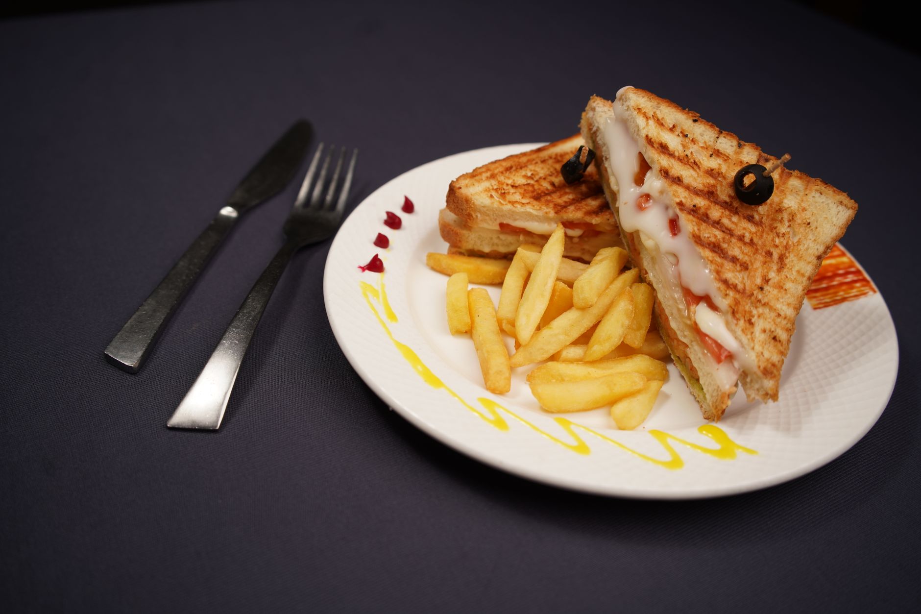 Grilled sandwich with cheese and filling served on a plate as a quick snack
