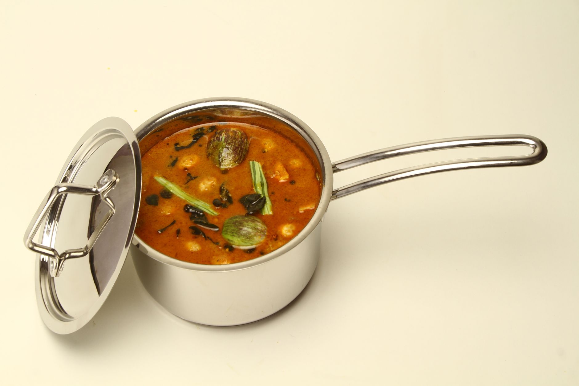 Stainless steel pot with Indian curry being cooked