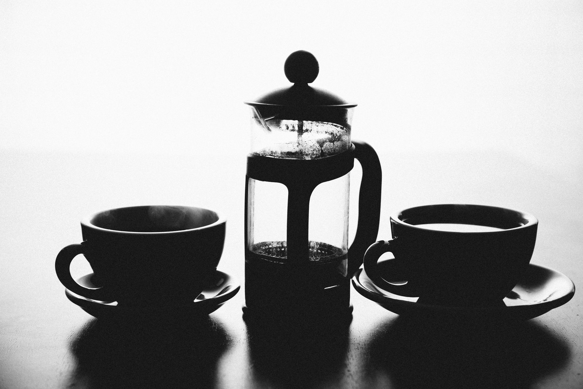 French press coffee maker with coffee cups