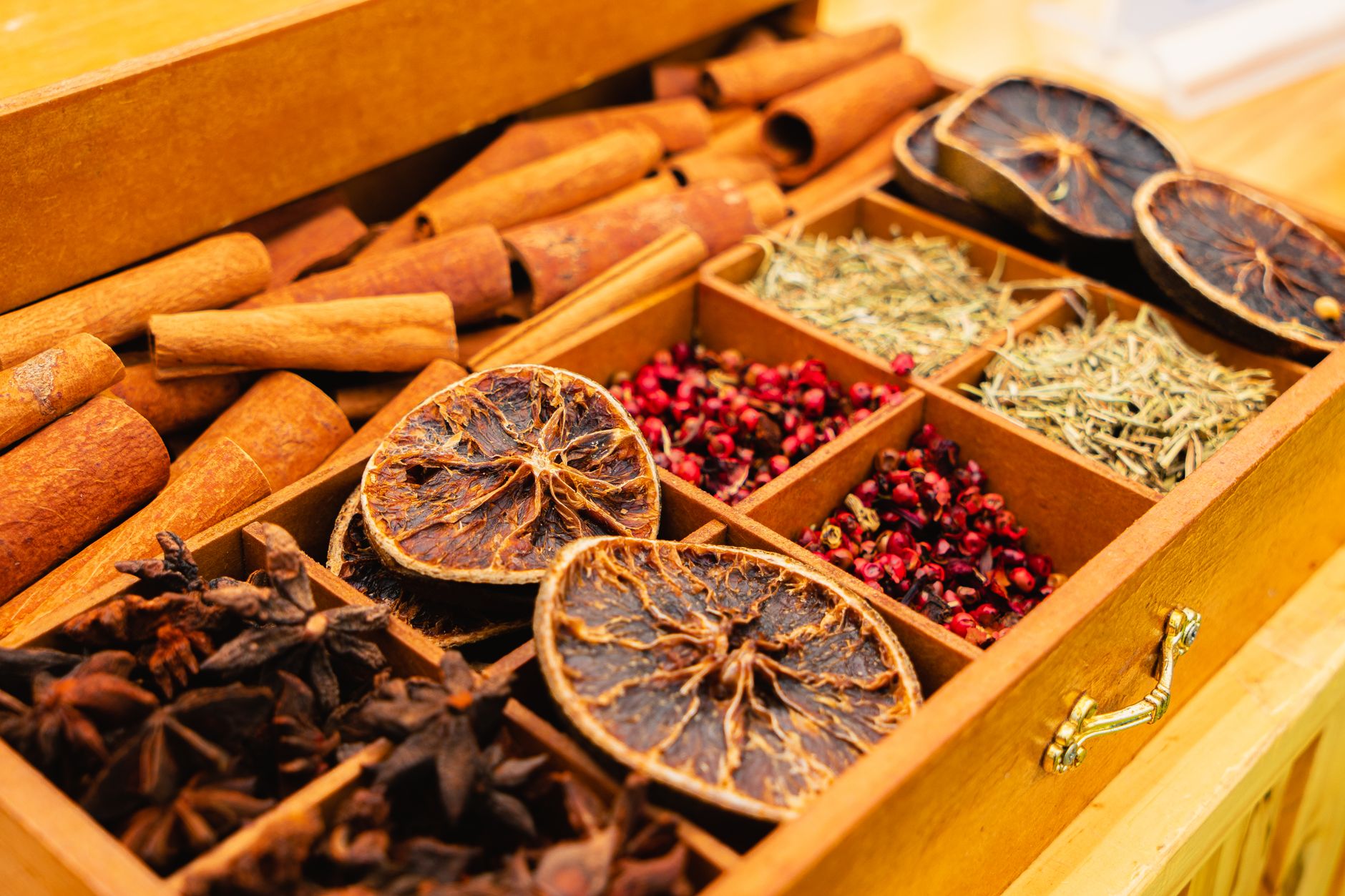 Wooden compartment spice box with whole spices and dried herbs for artisan kitchen storage