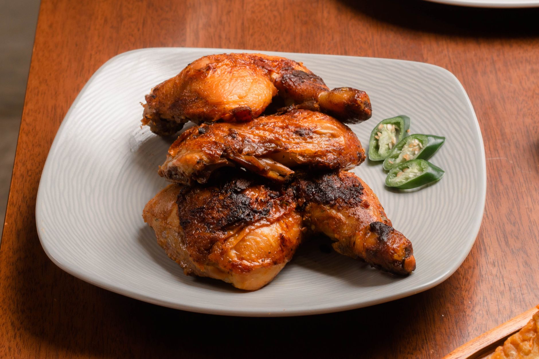 Spicy grilled chicken drumsticks on a plate — Havells Prolife Digi air fryer is capable of grilling and roasting alongside frying