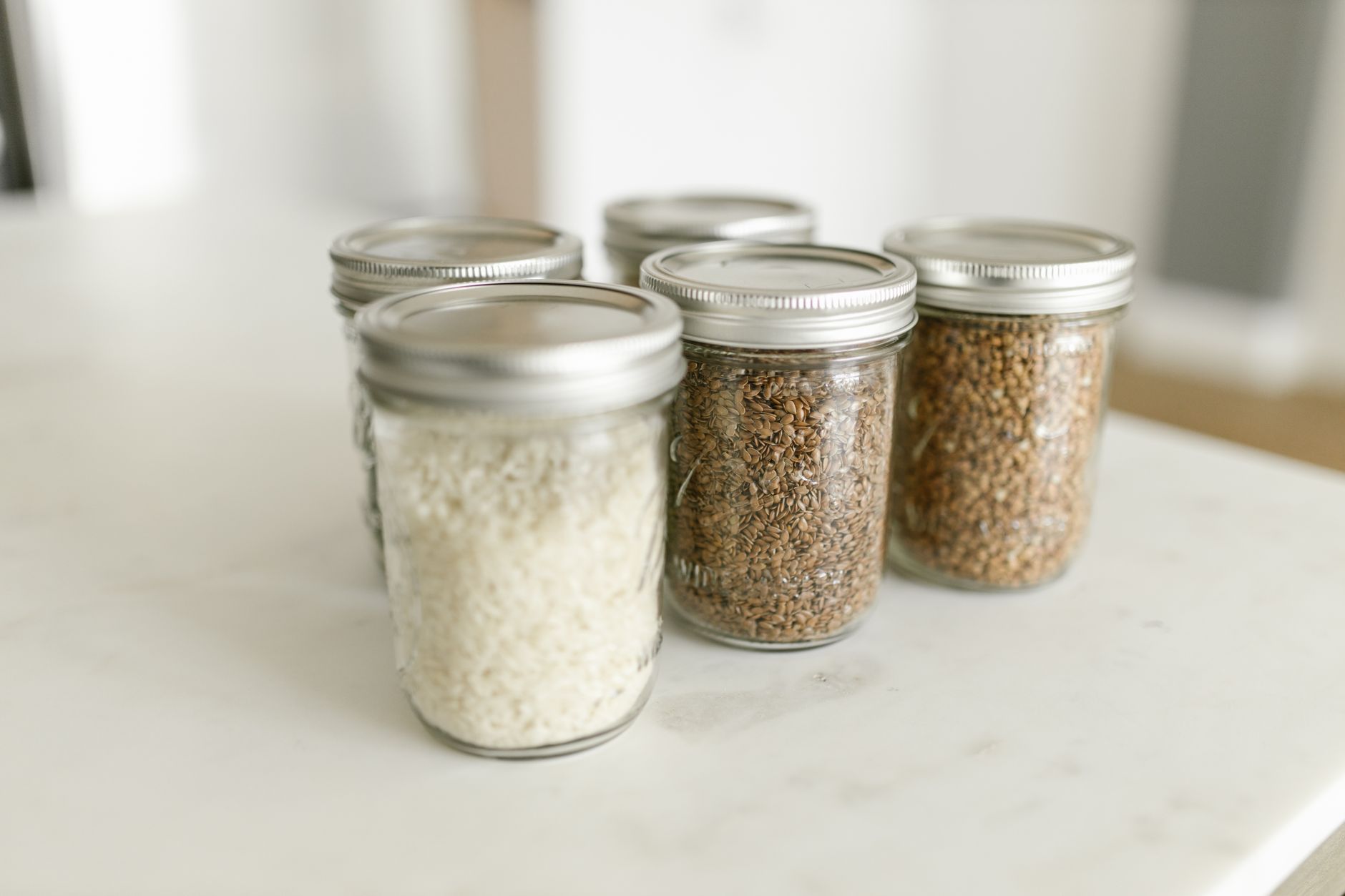 Glass jars with grains and rice for kitchen pantry organisation