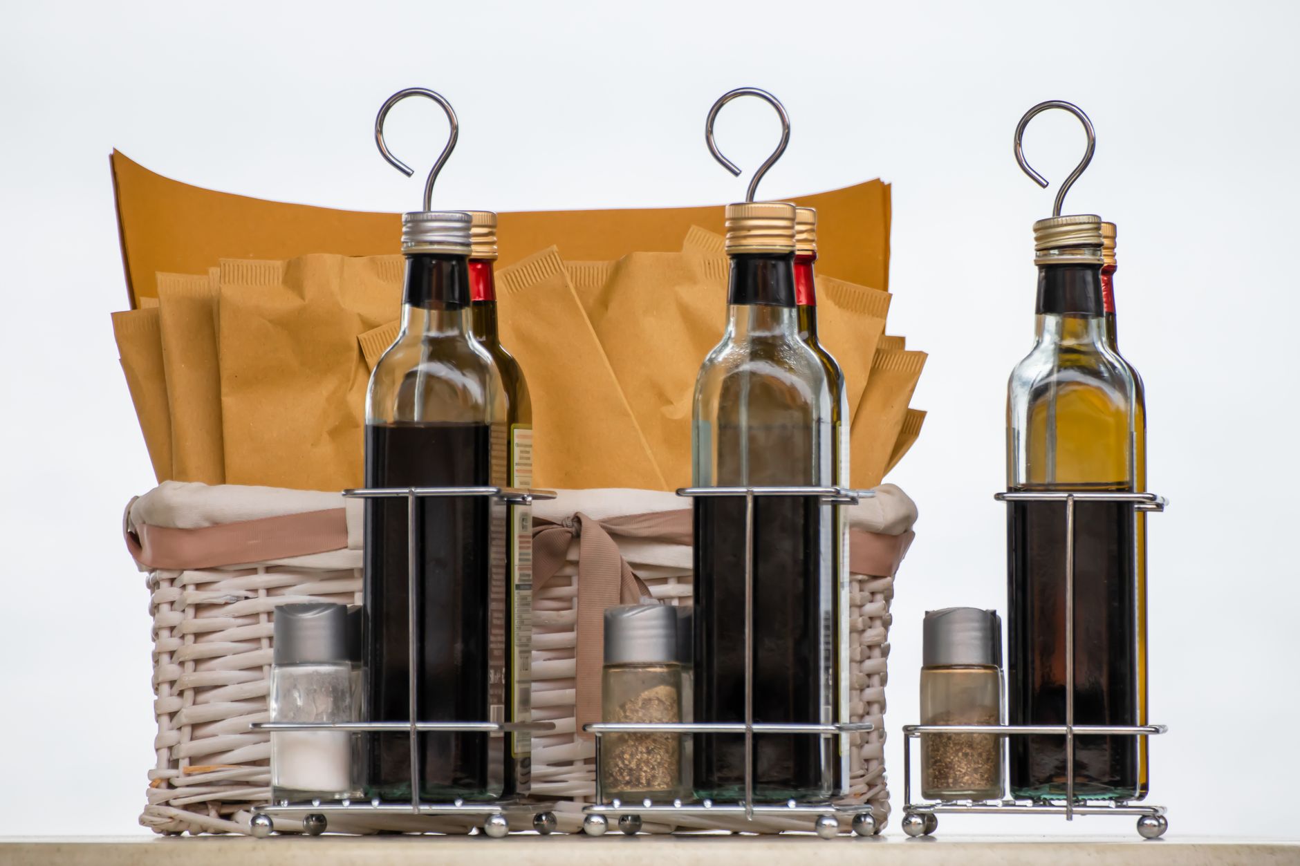 Glass spice bottles and condiment jars in kitchen storage organizer for countertop spice rack