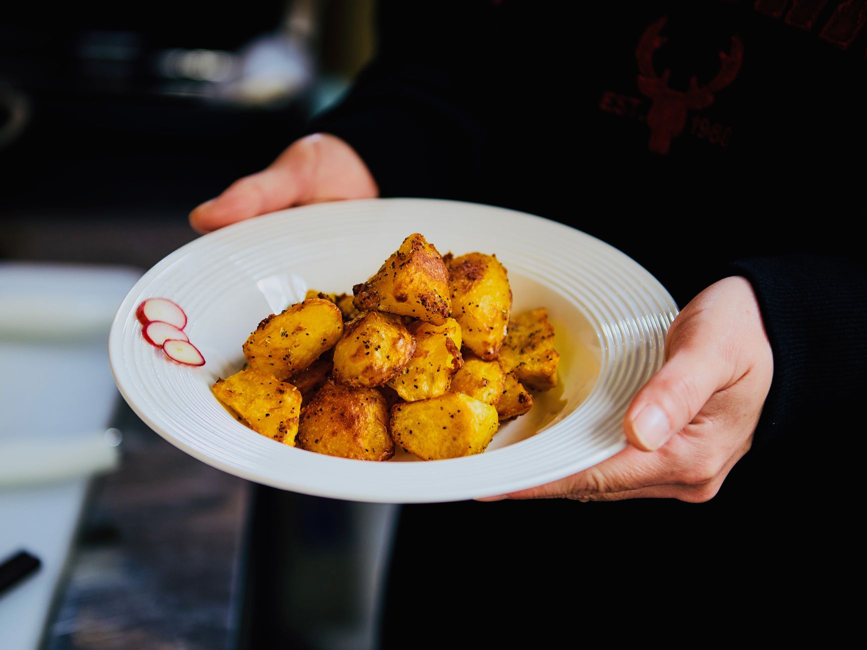 Golden roasted potatoes on a white plate — potatoes are one of the most popular dishes made in the Lifelong digital air fryer