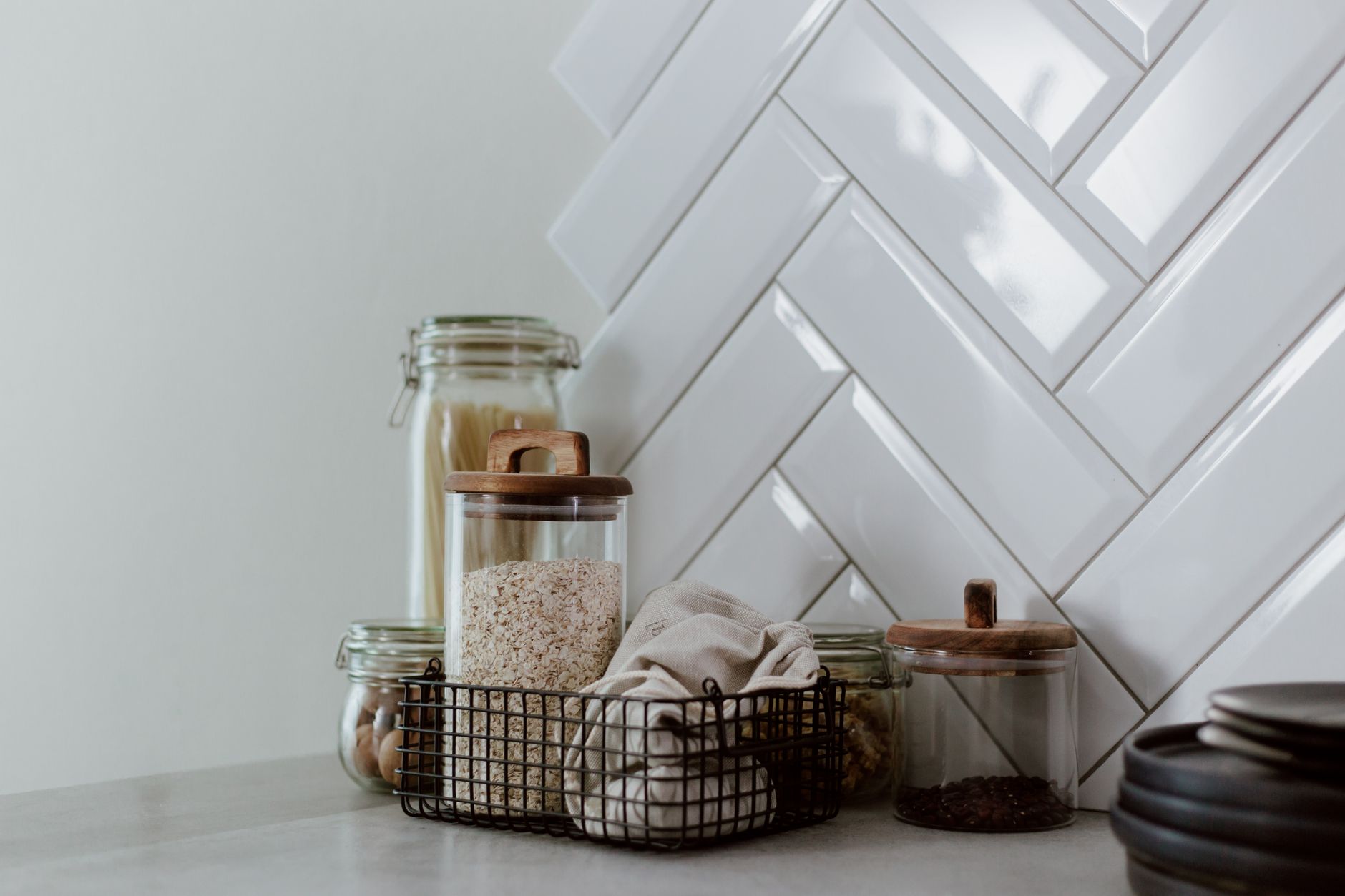 Modern kitchen counter with glass and steel storage jars for organised pantry