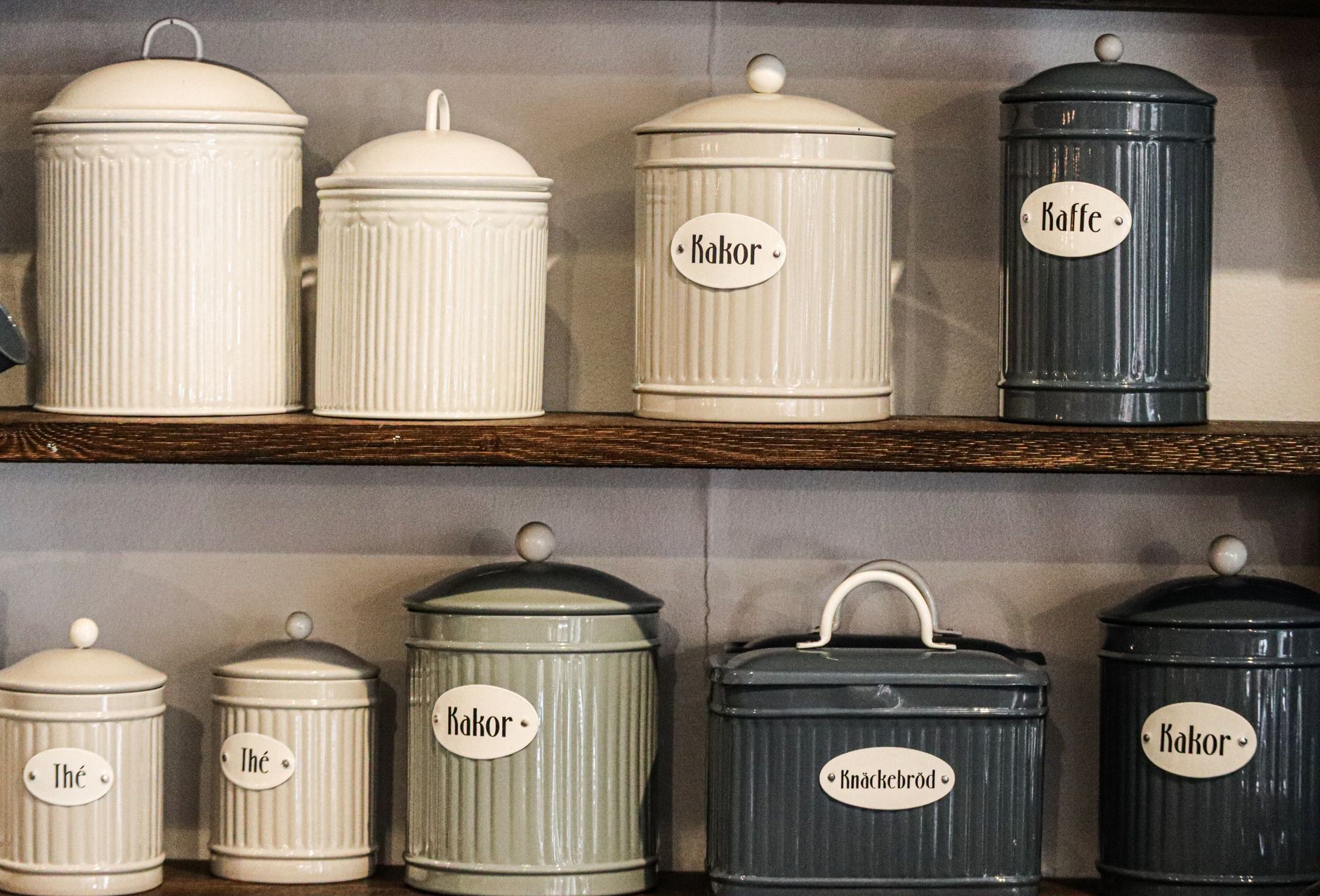 Retro-style kitchen storage containers on organised pantry shelves