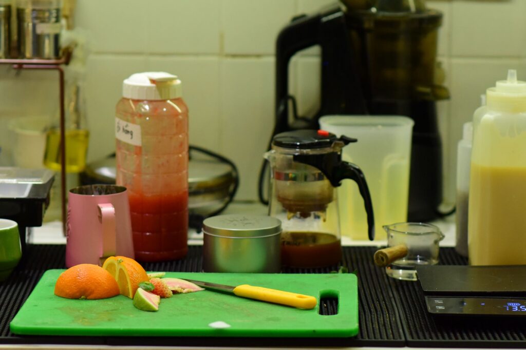 Electric juicer machine on kitchen counter with fresh citrus fruits for home juicing India