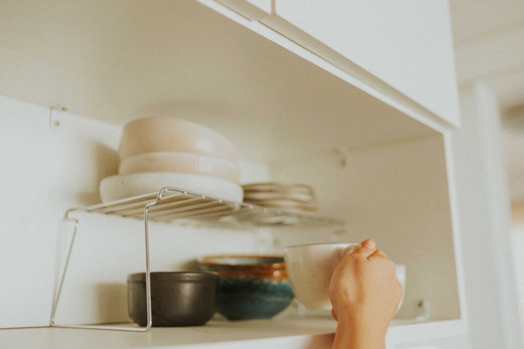 Kitchen cabinet organizer for Indian homes - neatly arranged dishes and storage