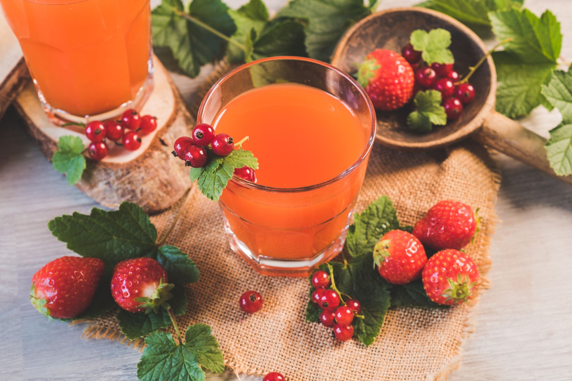 Fresh fruit juice in glass with strawberries and red currants for healthy drinks at home