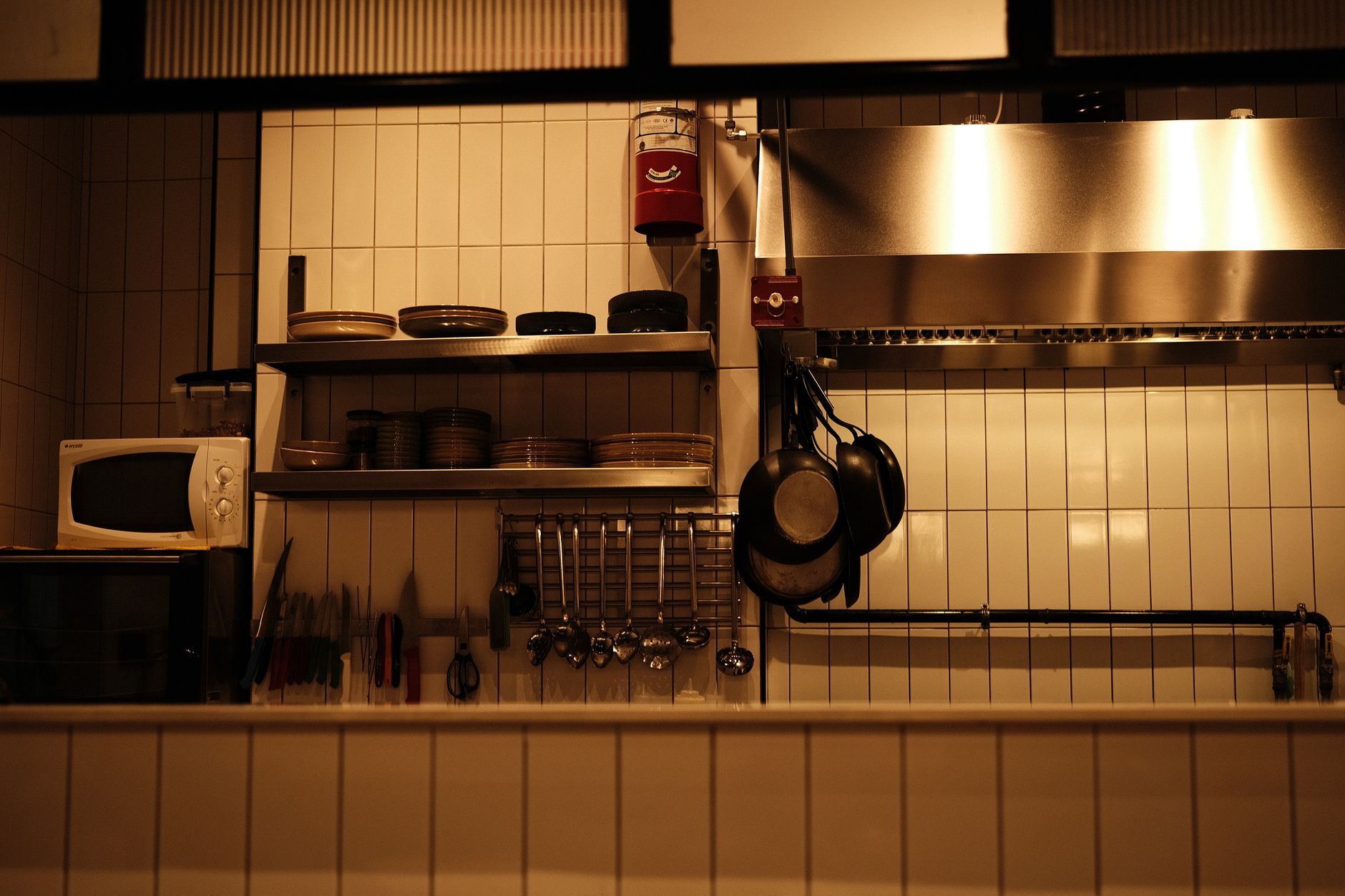 Well-organised kitchen with a microwave oven and cooking utensils