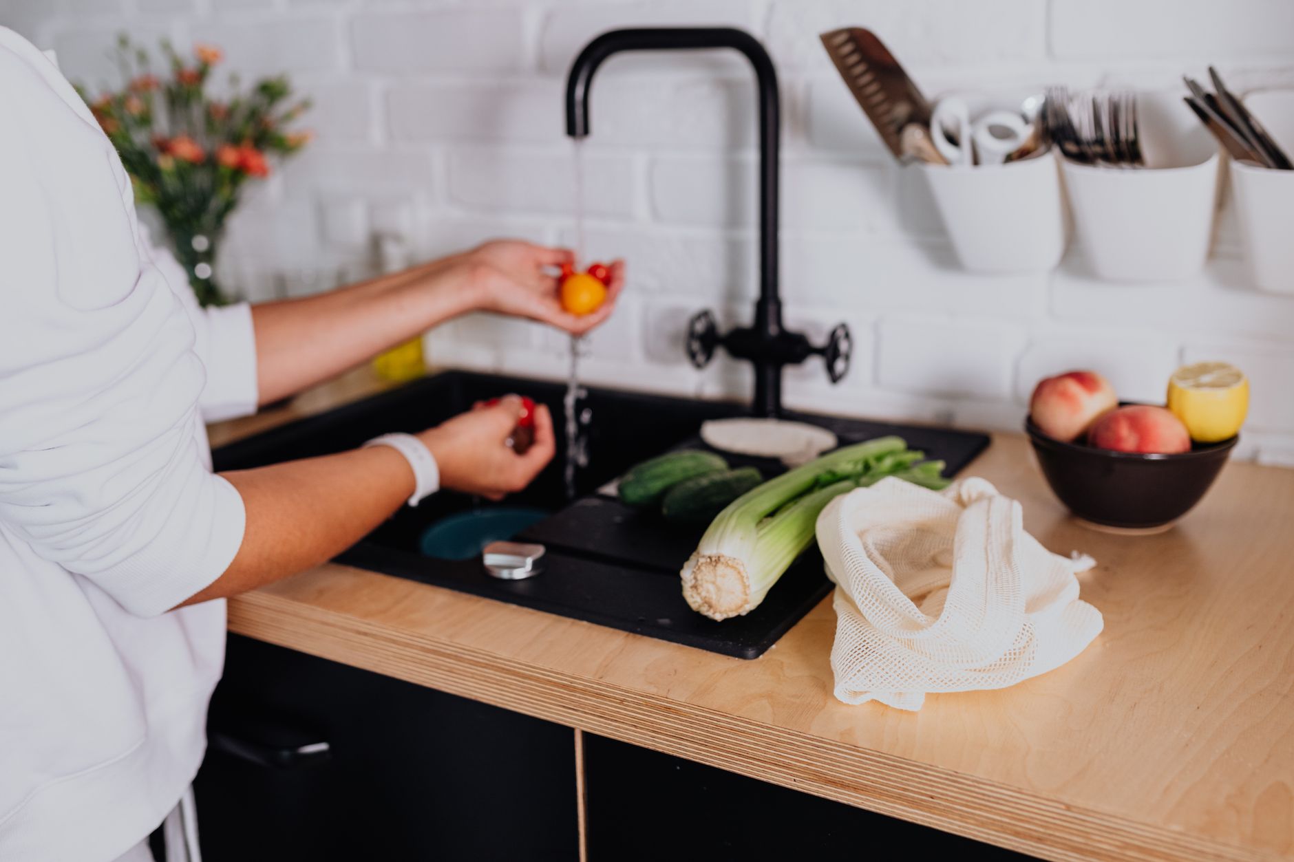 Woman preparing fresh vegetables in a modern Indian kitchen before chopping