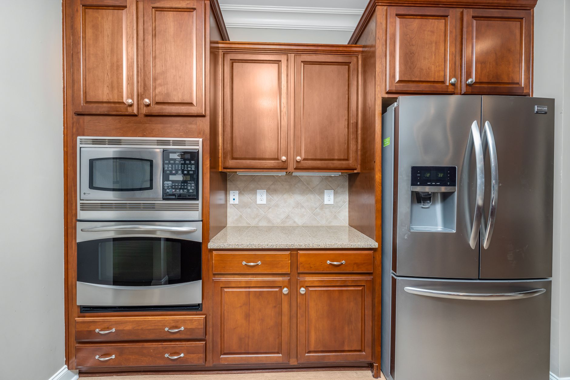 Modern kitchen with stainless steel appliances including microwave oven for Indian home cooking