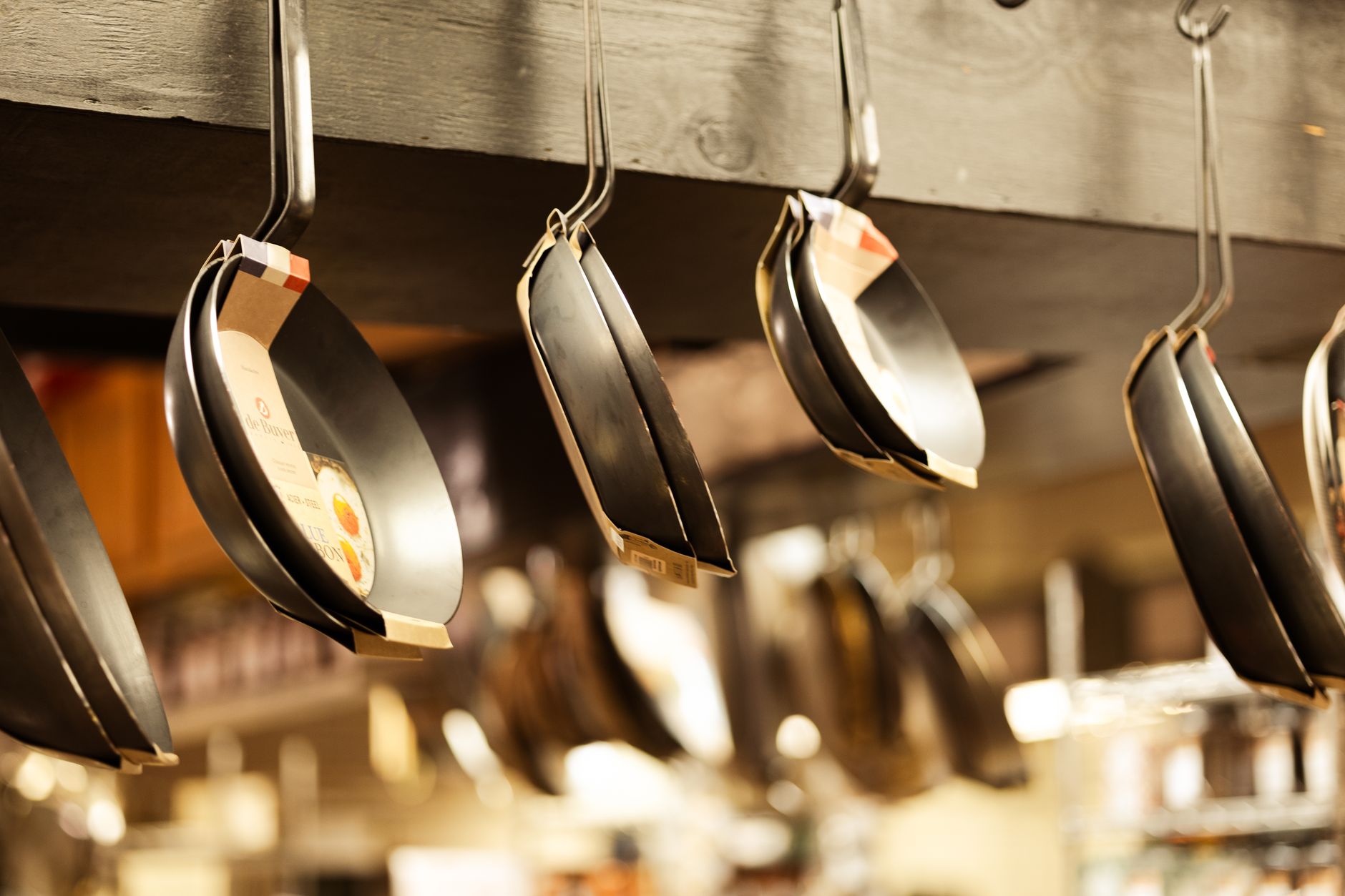 Range of non-stick frying pans and cookware displayed in a kitchenware shop India