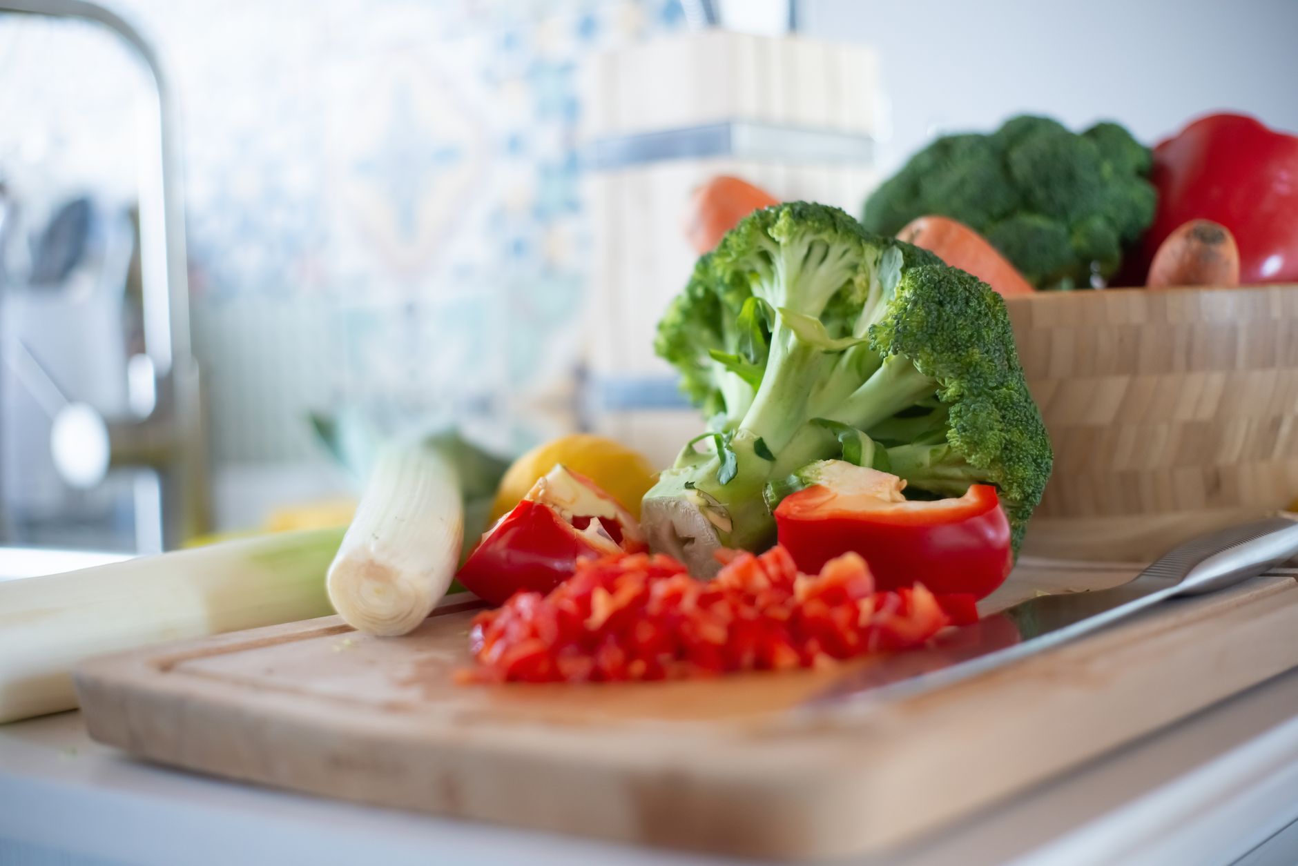 Colourful fresh vegetables including capsicum and broccoli ready for chopping